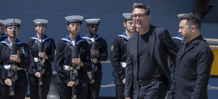 Britain's Prime Minister Andy Burnham walks with Ukraine's President Volodymyr Zelensky (R) at a welcoming ceremony, during their visit to HM Naval Base in Portsmouth, England on July 27, 2026. 