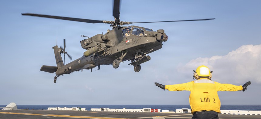 A U.S. Army AH-64 Apache helicopter prepares to land on the Wasp-class amphibious assault ship USS Essex as part of Exercise Rim of the Pacific 2026, July 19, 2026.