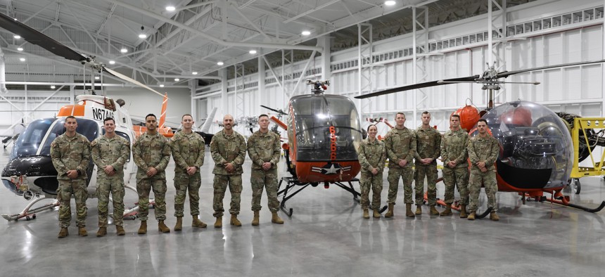 Army aviation students who are slated to participate in a contractor owned and operated Flight School Next pilot program, gather for a photo at Fort Novosel, Ala., March 28, 2025.