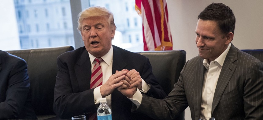 Donald Trump shakes Peter Thiel's hand during a meeting with technology executives, December 14, 2016.