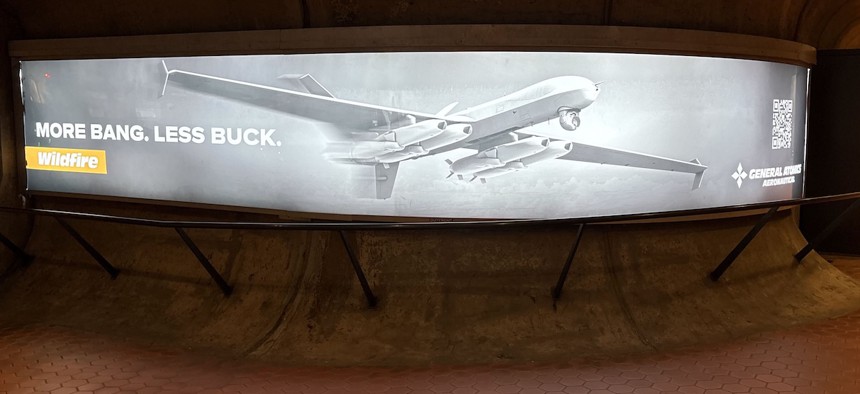 An advertisement for General Atomics' Massed Modular Aircraft offering in the Pentagon metro station.
