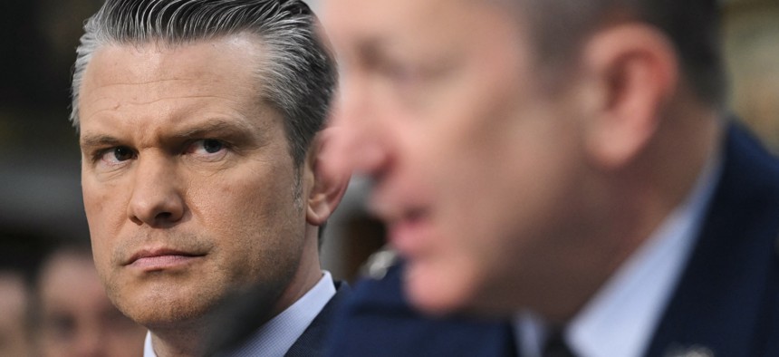 Defense Secretary Pete Hegseth looks on as Joint Chiefs chairman Gen. Dan Caine testifies to Congress on May 12, 2026.