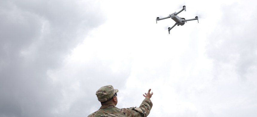 A soldier with the 101st Airborne 2-327 Multi-Purpose Company catches a drone in the Pentagon parking lot on June 14, 2025. 