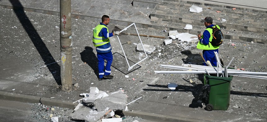 Municipal workers clear debris after a Russian drone struck an apartment building in Galati, Romania, a member of NATO, on May 29, 2026.