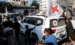 Hamas members hand over some of the 20 Israeli hostages to International Committee of the Red Cross teams as part of a ceasefire and hostage-prisoner exchange agreement between Hamas and Israel on October 13, 2025 in Gaza.
