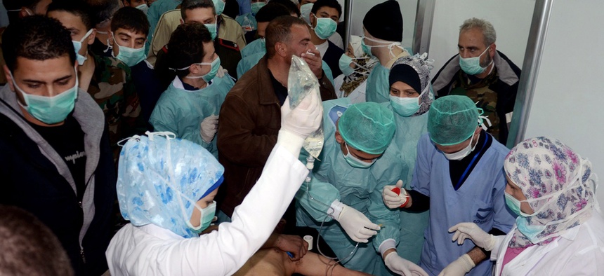 Doctors treat a victim of an a possible chemical attack at a village in Syria