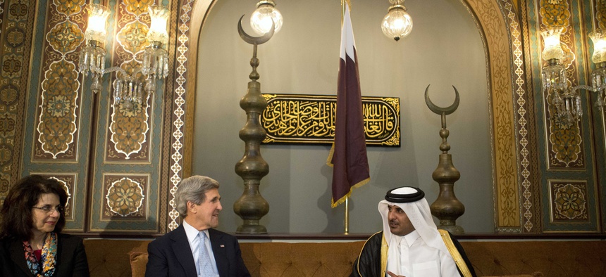 Qatar's leader Sheik Tamim bin Hamad Al Thani speaking with Secretary of State John Kerry