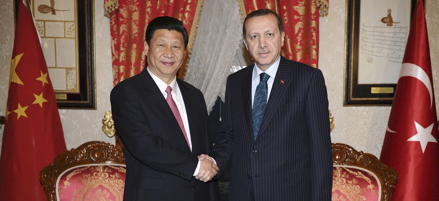 Then Chinese Vice President, and current President Xi Jinping, left, shakes hands with Turkey's Prime Minister Recep Tayyip Erdogan in Istanbul, Turkey, Feb. 21, 2012.