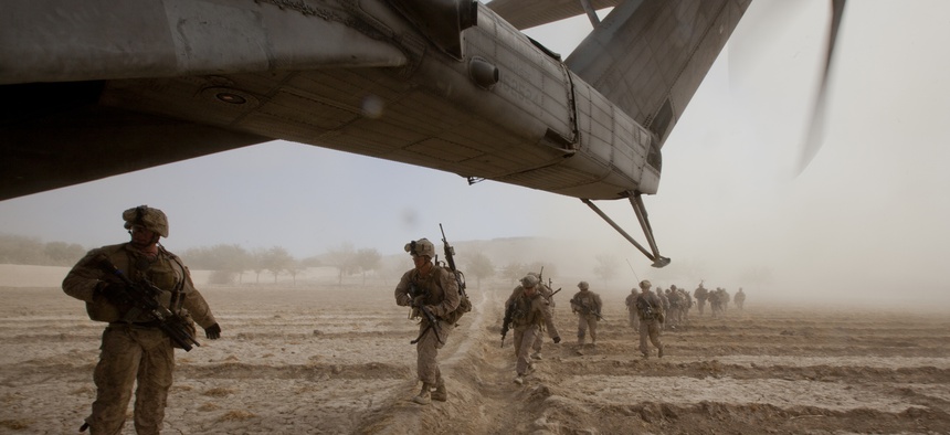 In Gurjat, Helmand province, Afghanistan, U.S. Marines with Bravo Company, 1st Battalion, 9th Marine Regiment run toward a CH-53E Super Stallion, Oct. 28, 2013.