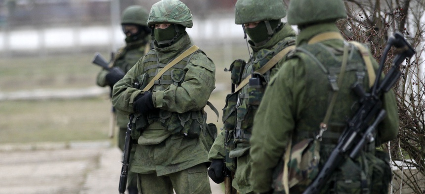Unidentified gunmen guard Ukraine's infantry base in Privolnoye, Ukraine, on Sunday.