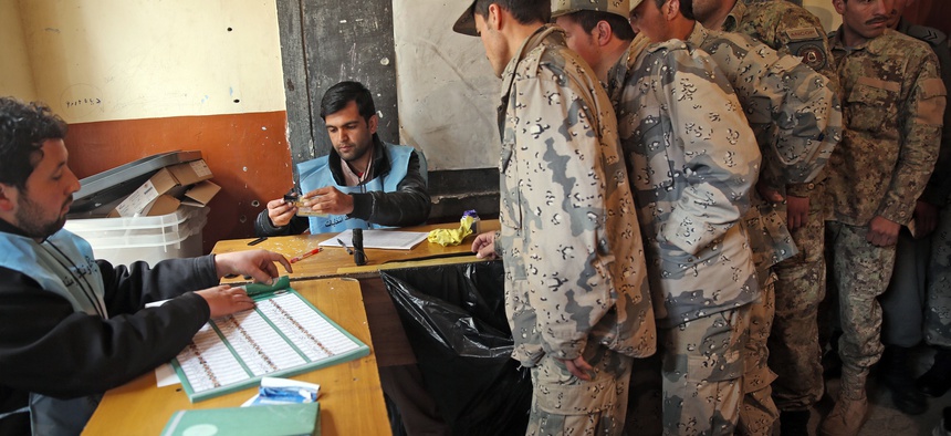 Afghan security forces cast their votes at a polling station in Kabul, Afghanistan, Saturday, April 5, 2014.