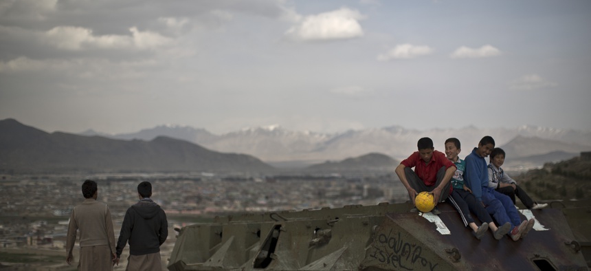 Afghan youths overlooking Kabul on Tuesday, April 1, 2014.