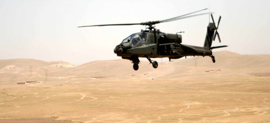 An Apache attack helicopter flies a route between Tall'Afar and Mosul, Iraq, in June 2006.