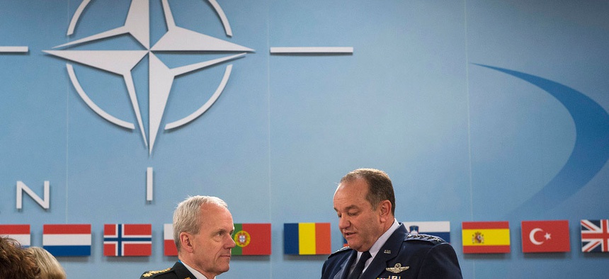 At right, NATO’s Supreme Allied Commander for Europe, Gen. Philip Breedlove, speaks with Chairman of the NATO Military Committee, General Knud Bartels, during a meeting of NATO defense ministers in June 2013.