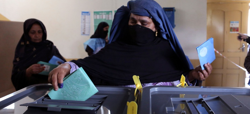 An Afghan woman casts her vote at a polling station in Jalalabad east of Kabul, Afghanistan, Saturday, April 5, 2014.