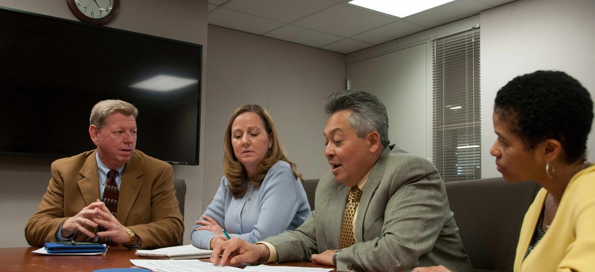 Civilian employees at Robins Air Force Base discussing manning and labor issues at a meeting