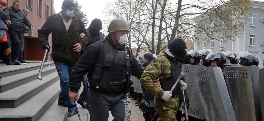 Pro-Russian activists leaving the office of the regional prosecutor in Donetsk, Ukraine