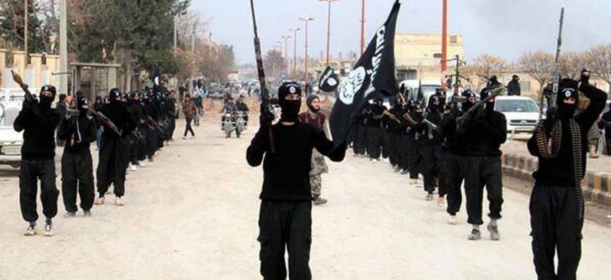 Fighters with the al-Qaeda linked Islamic State of Iraq and the Levant march through Raqqa, Syria