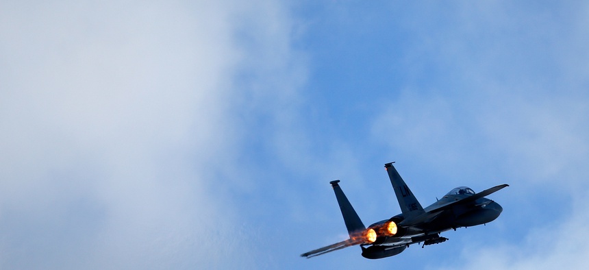 A U.S. F15C Eagle jet fighter flies over Lithuania for a NATO exercise at the Siauliai airbase, April 2, 2014.