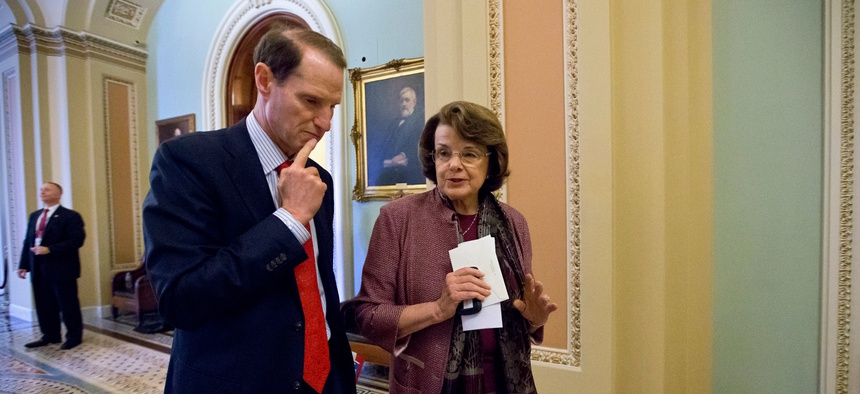 Sen. Ron Wyden, D-Ore., walks with Sen. Dianne Feinstein, D-Calif. on Capitol Hill in June 2013.