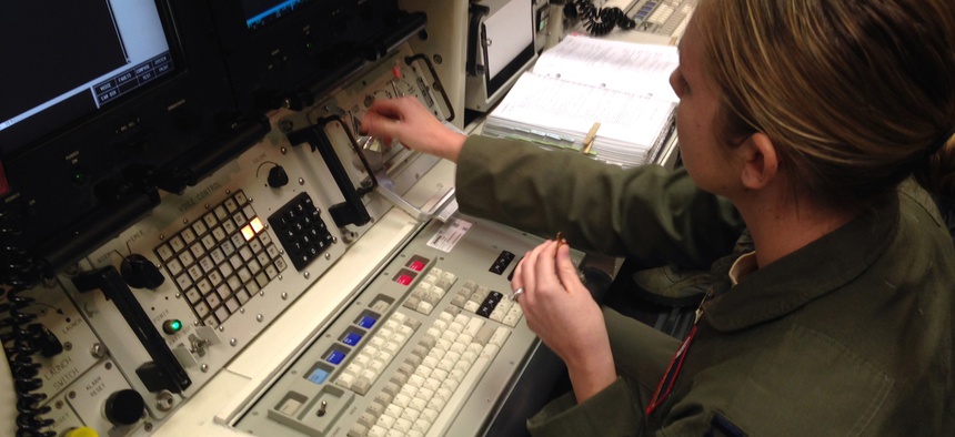 A Minuteman 3 missile launch officer at the console of a launch simulator used for training at F. E. Warren Air Force Base, Wyo., on Jan. 9, 2014.