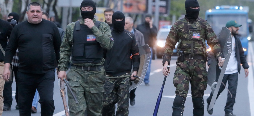 Masked pro-Russian activists walk down the streets of Donetsk, Ukraine on April 28.