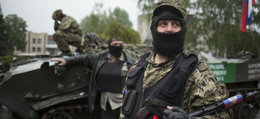 Pro-Russian gunmen guard the central square of Slovyansk, eastern Ukraine, Friday, May 2, 2014.