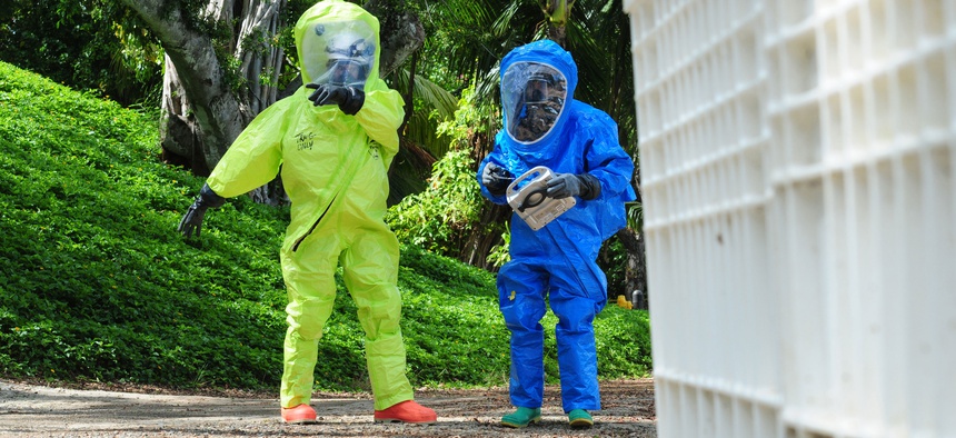 Two soldiers with the 9th Civil Support Team, California National Guard, identify hazardous materials during a training in Kaneohe Bay, Hawaii.