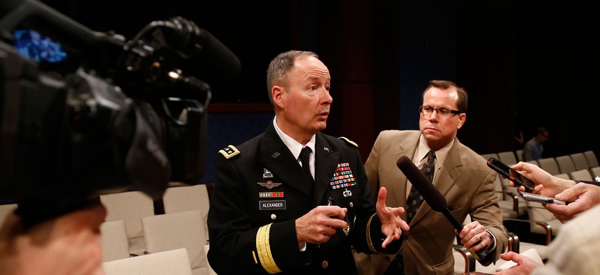 Former NSA Director retired Gen. Keith Alexander, pictured here last June, speaks to reporters after a hearing on Capitol Hill.