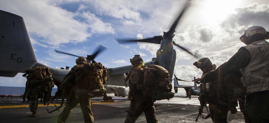 Troops with the 22nd Marine Expeditionary Unit load onto an MV-22 Osprey before a bilateral exercise with the Hellenic Army on March 7, 2014.