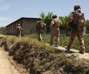 Army soldiers from the Czech Republic and the U.S. Army’s 1st Mechanized Company, 41st Battalion, 4th Rapid Deployment Brigade, patrol through the village of Dehe-Qadzi in Parwan province on Tuesday.