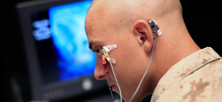 A Marine sits through an eye blink study with sensors attached to his face while taking psychological tests at the Marine Corps Air Ground Combat Center in Twentynine Palms, Calif., Sept. 29, 2009.