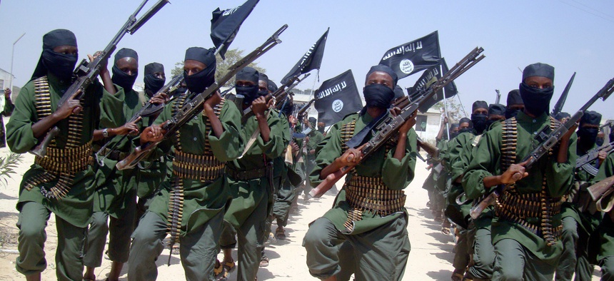 Al-Shabab fighters march with their weapons during military exercises on the outskirts of Mogadishu, Somalia, Feb. 17, 2011. At least twice in 2013 Twitter shut down the handle of al-Shabab.