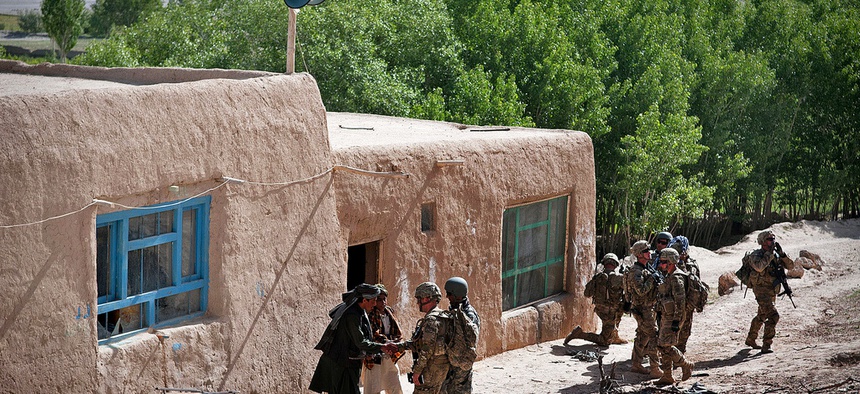 Paratroopers with the 82nd Airborne Division pull security outside a madrassa as Afghan soldiers search for weapons inside, on May 29, 2012.
