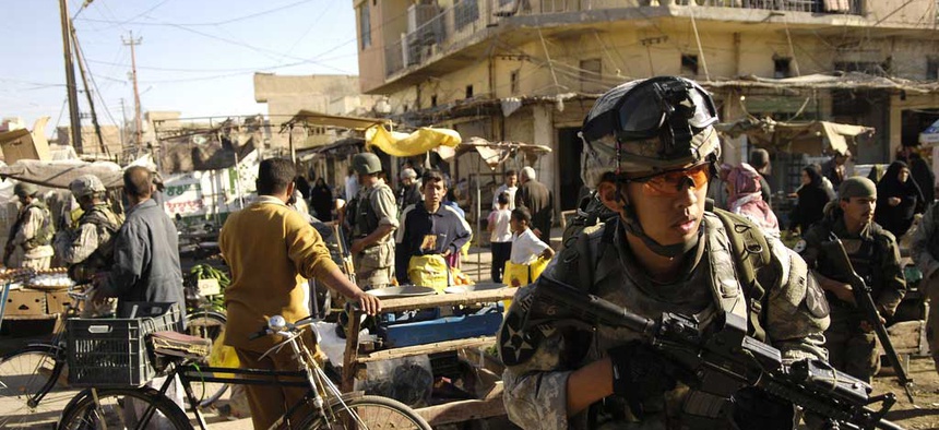 An Army specialist move through an open air market during a foot patrol in Baqubah, Iraq, on April 5, 2007.