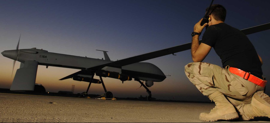 An airman at Ali Air Base in Iraq communicates with the pilot of an MQ-1 Predator drone, on November 5, 2007.