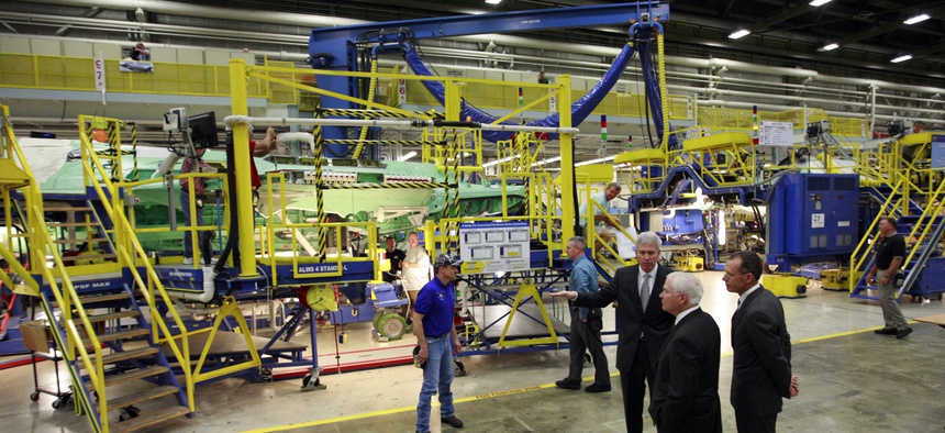 Former Defense Secretary Bob Gates inspects a F-35 Lightning II assembly line during a visit to a Lockheed Martin plant, on August 31, 2009.