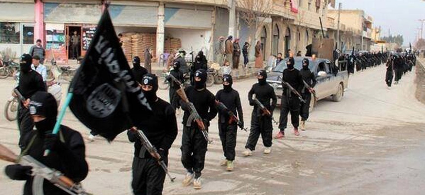 This undated file image posted on a militant website on Tuesday, Jan. 14, 2014 shows fighters from the al-Qaida linked Islamic State of Iraq and the Levant (ISIL) marching in Raqqa, Syria. The ISIL led by Abu Bakr al-Baghdadi, who is believed to have been