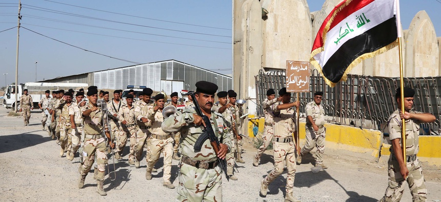 Members of the Iraqi Army march inside a recruiting center in Baghdad, Iraq, on June 19, 2014. 
