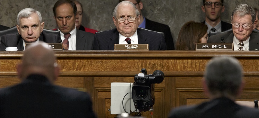 Sens. Jack Reed, D-R.I., Carl Levin, D-Mich., and James Inhofe, R-Okla., listen during a Armed Services Committee hearing, on April 3, 2014.