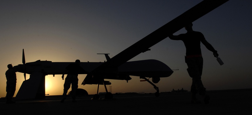 U.S. airmen conduct a pre-flight inspection on an MQ-1 Predator Unmanned Aerial Vehicle Nov. 5, 2007, at Ali Base, Iraq.
