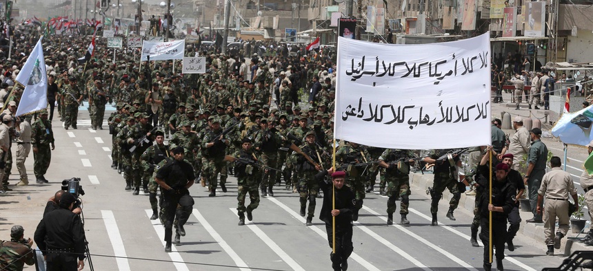 Volunteers of the newly formed "Peace Brigade" march in a demonstration in Sadr City, Baghdad, Iraq, on June 21, 2014.