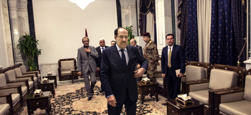 Iraqi Prime Minister Nouri al-Maliki waits for Secretary of State John Kerry ahead of a meeting on June 23, 2014.