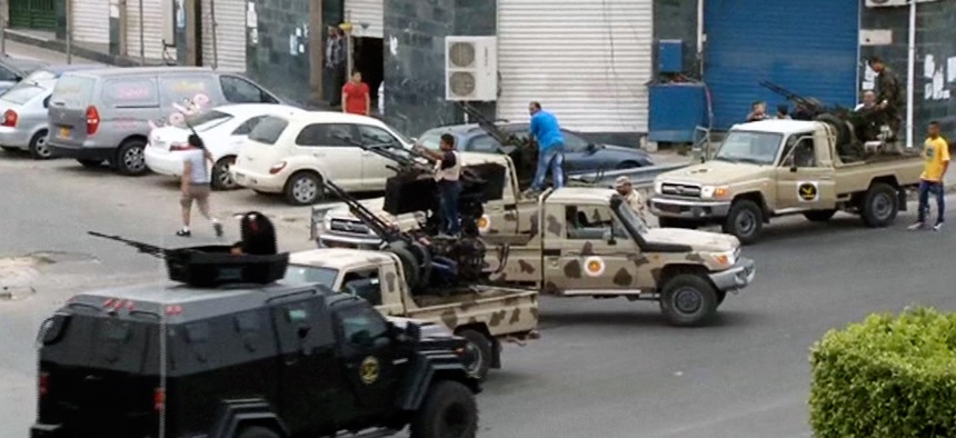 Tripoli joint security forces guard the entrance road to the parliament area after troops of Gen. Khalifa Hifter targeted Islamist lawmakers and officials at the parliament in Tripoli, Libya, in mid May.