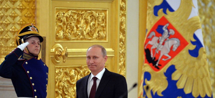 Russian President Vladimir Putin enters a hall for a ceremony to honor the Russian national ice hockey team, on May 27, 2014.