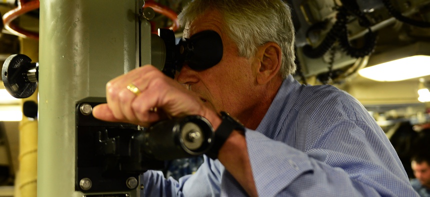 Defense Secretary Chuck Hagel tries the periscope aboard the Ohio-class nuclear submarine USS Tennessee at Submarine Base Kings Bay, Ga. Jul. 9, 2014.
