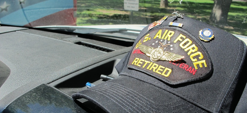 A Vietnam War veteran's cap sits on the dashboard of a vehicle used to transport veterans to medical appointments in New Mexico.