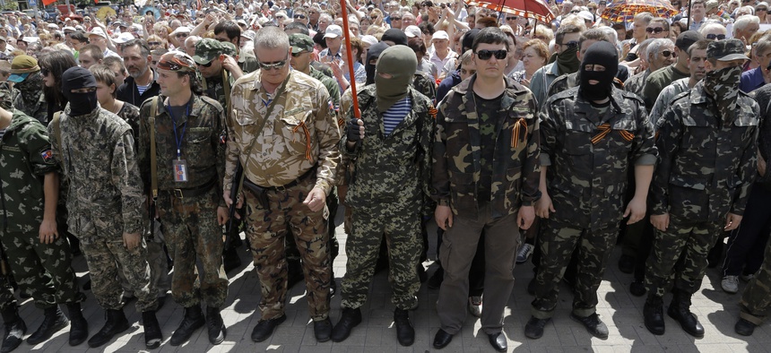 Pro-Russian fighters in the city of Donetsk gather to take an oath of allegiance to the self-proclaimed Donetsk People, on June 22, 2014.