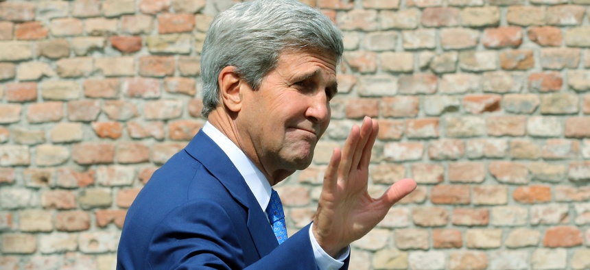 U.S. Secretary of State John Kerry waves as he arrives in front of a hotel where closed-door nuclear talks on Iran take place in Vienna, Austria, July 14, 2014.