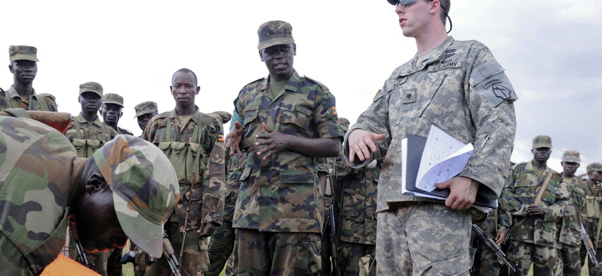 A soldier with the Georgia National Guard practice establishing drop zones with the Ugandan People's Defense Forces during an exercise sponsored by U.S. Army Africa.